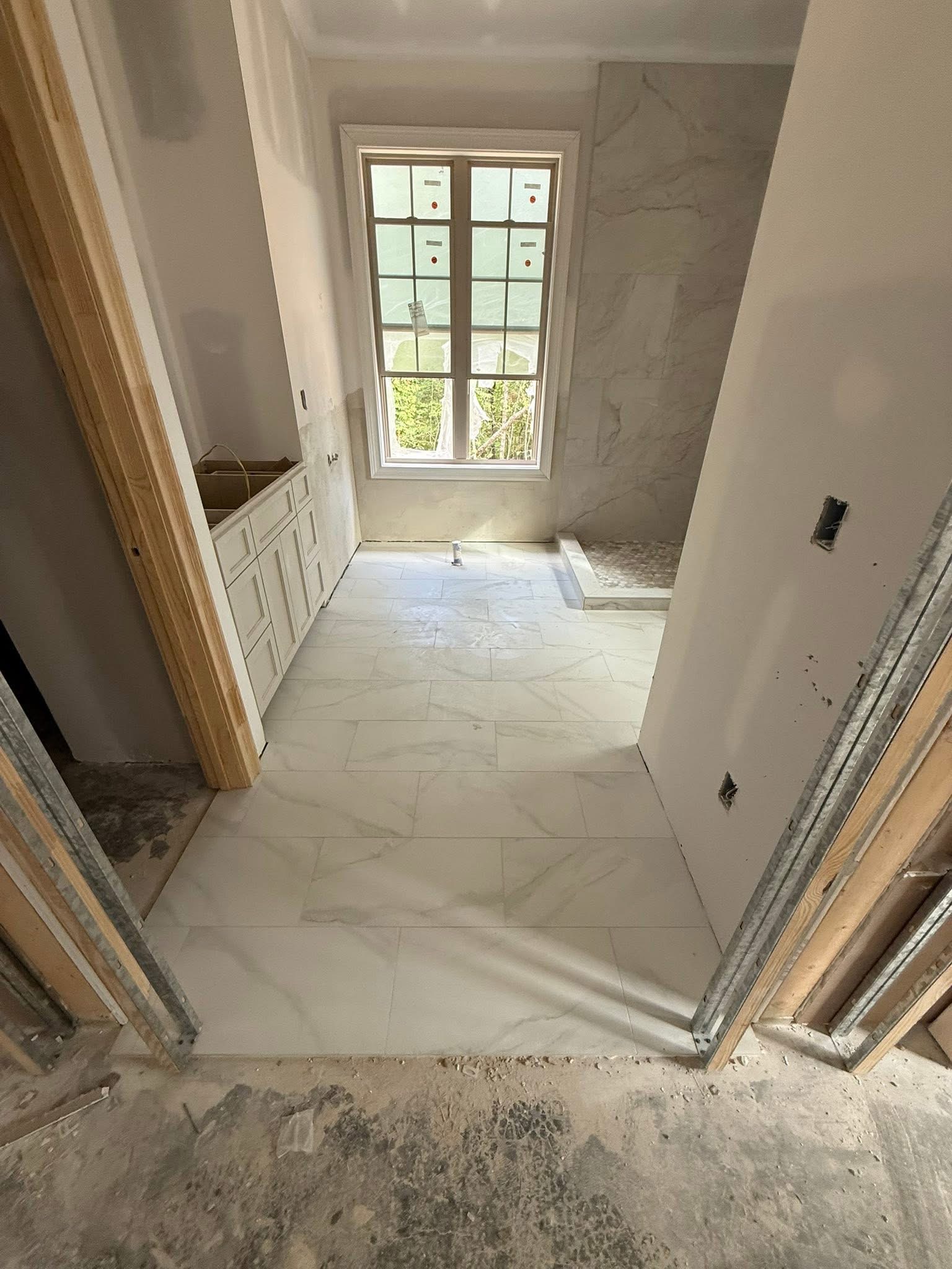 Finished bathroom with marble tile and natural light