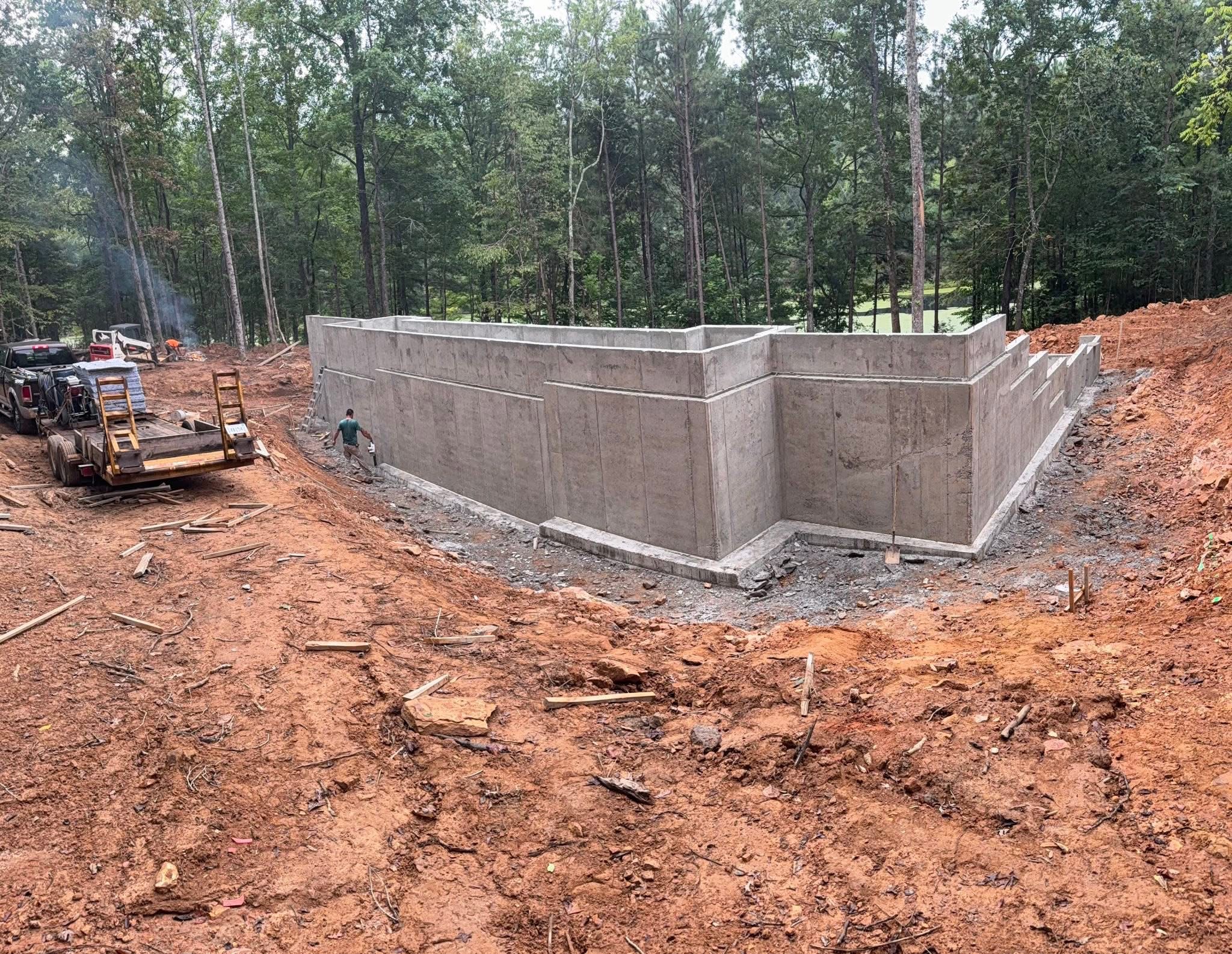 Concrete foundation walls poured into the sloped lakeside terrain