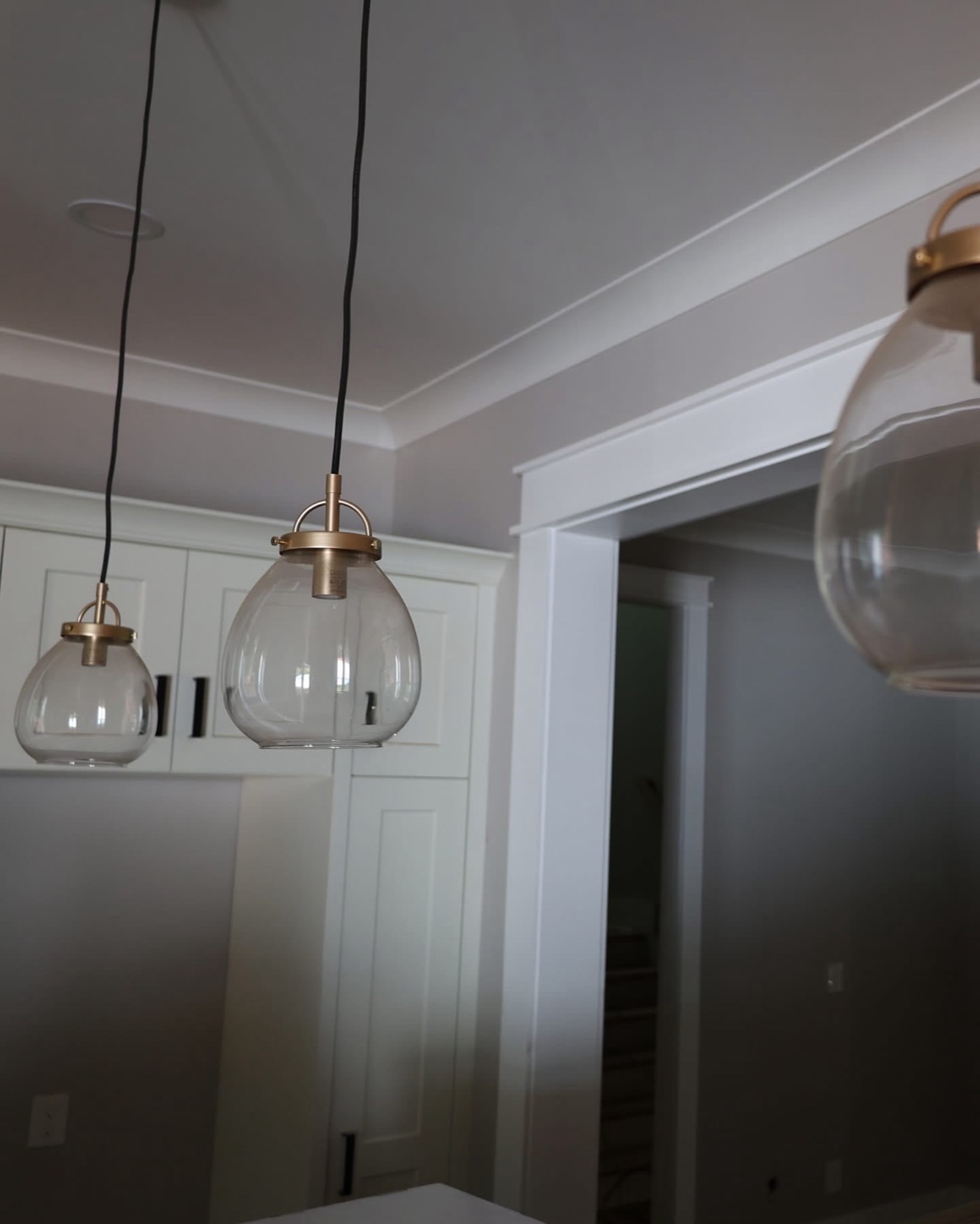 Brass-and-glass pendant lights above the kitchen island